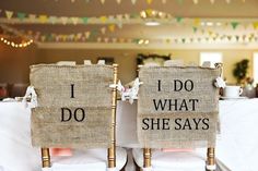 two burlap chairs with i do and what she says signs on the back