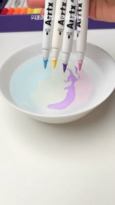 three markers are being used to draw on a plate