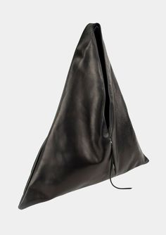 Angular sculpted black leather tote bag with an exterior zip pocket. Lined in a durable cotton canvas with inside leather cell phone pocket. Worn comfortably on the shoulder and hand held.Materials:100% Italian Cowhide Leather100% Cotton Canvas LiningSilver Zippers Dimensions:Handle drop - 14″Width - 24.5″Height - 26.5″Bottom Depth - 3″ Closet Manifestation, Triangle Tote, Luxury Gloves, Positive Aura, Leather Work Bag, Triangle Bag, Black Leather Tote Bag, Black Leather Tote, Leather Bags Handmade