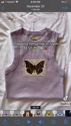 a purple shirt with a butterfly on it and the words dropping tomorrow at 12pm est