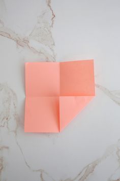 an orange piece of paper sitting on top of a white counter