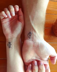 two people with matching tattoos on their arms and feet, one has a diamond in the middle