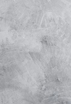 a gray concrete wall textured with white paint