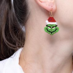 Funny Christmas earrings, Grinch face beaded earrings, Brick stitch Miyuki earrings,Beadwork winter earrings,Christmas gift, Green earrings.    Get into the holiday spirit with my  Funny Christmas Earrings! These delightful Grinch Face Beaded Earrings are crafted using intricate Brick Stitch with high-quality Miyuki beads, making them a unique addition to your winter wardrobe. Perfect for festive gatherings or a cheerful gift, these beadwork winter earrings will add a playful touch to any outfit Christmas Brick Stitch Earrings, Beaded Earrings Brick Stitch, Holiday Beaded Jewelry, Miyuki Earrings, Grinch Face, Beads Making