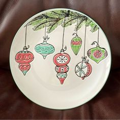 a white plate with ornaments hanging from it