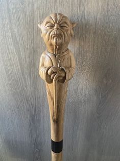 a wooden carving of a demon holding a baseball bat