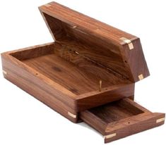 an open wooden box sitting on top of a white surface