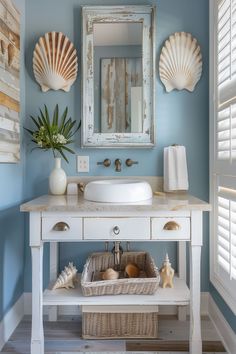 a white sink sitting under a bathroom mirror next to a wooden shelf filled with seashells