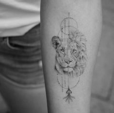 a black and white photo of a lion's face on the right thigh with geometric lines