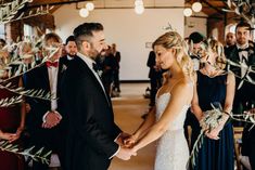 a bride and groom holding hands at their wedding ceremony