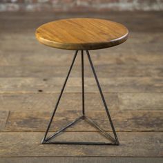 a small wooden table sitting on top of a wooden floor