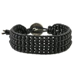 Siriporn of Thailand designs a handcrafted wristband bracelet showcasing the power and sophistication of black. Three rows of matte black glass beads are wrapped to black leather cords knotted at the ends. The bracelet fastens with a silver button stamped with a flower from the Karen hill tribe of Thailand. The bracelet has two loops for securing the silver button for an adjustable fit. Adjustable Wristband With Black Round Beads, Adjustable Black Beads Wristband, Black Adjustable Spiritual Wrap Bracelet, Adjustable Wrap Bracelet With Black Round Beads, Adjustable Black Beads Wrap Bracelet, Handmade Black Spiritual Leather Bracelet, Adjustable Wrap Bracelet With Black Beads, Adjustable Hand-wrapped Black Bracelets, Adjustable Black Wristband With Round Beads