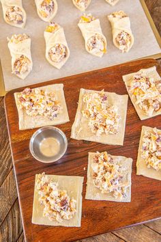 some food that is sitting on top of a wooden table and ready to be baked