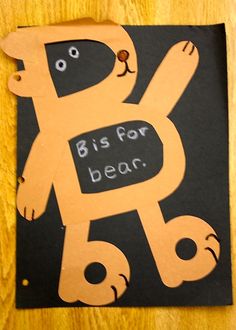 a piece of paper cut out to look like a dog with the words bis for bear on it