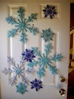 snowflakes are hanging on the front door to decorate with blue and white frosting