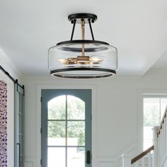 a light fixture hanging from the ceiling in a hallway