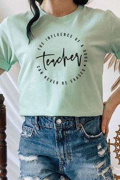 Introducing "The Influence Of A Good Teacher Can Never Be Erased" Heart Graphic Tee from Kissed Apparel. Elevate your merchandise with this impactful and meaningful design. Most t shirt colors are 52/48 cotton/poly blend. White and Cream tees are 100% cotton, Ash tees are 99/1 cotton/poly. Perfect for celebrating the lasting impact of teachers. Order now to enhance your back to school line and captivate customers with this inspiring and heartfelt tee.Made In: USAFabric Contents: Most t-shirt col Inspirational Cotton Tops With Text Print, Inspirational Cotton Tops With Slogan, Inspirational Cotton Slogan Tops, Inspirational Cotton Crew Neck T-shirt, Trendy Screen Print T-shirt For Teacher Appreciation, Inspirational Cotton Tops For Summer, Inspirational Cotton Tops With Screen Print, Inspirational Cotton Top With Screen Print, Inspirational Cotton Summer Tops