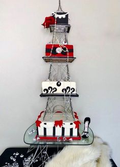 the tower cake is decorated with red, white and black designs on it's sides