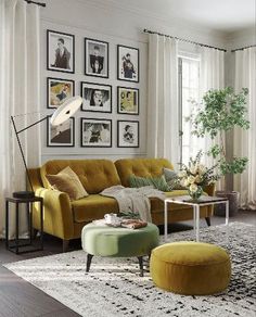 a living room with yellow couches and pictures on the wall above them, along with a coffee table