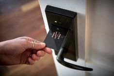 a person's hand is pressing the button on an appliance that reads h