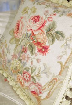 a close up of a pillow with flowers on it