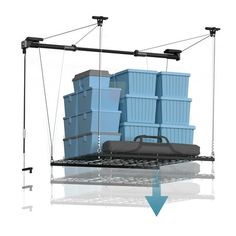 a bunch of blue containers on a metal rack with one hanging from it's side