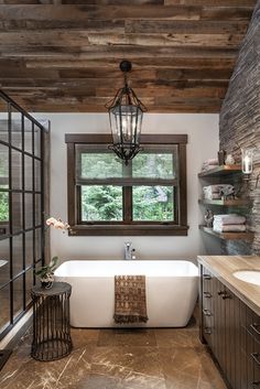 a bathroom with a bathtub, sink and window