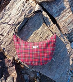 Our Tommy bags have a minimalist style. These red tartan plaid and blue white gingham versions have an outside zipper pocket. The bag is padded but still is very soft. It has adjustable straps that can go from a should bag lenght to crossbody. Measurements : 7x21x38cm. The red one has black plastic strap while the blue one has a strap made with the same fabric.  We make everything ourselves with fabric we source from producers or secondhand sellers. We try to repurpose over-production or secondh Plaid Bags With Adjustable Strap, Plaid Bags With Adjustable Strap For Everyday Use, Everyday Plaid Bag With Adjustable Strap, Plaid Shoulder Bag For Everyday Use, Everyday Gingham Bag With Adjustable Strap, Gingham Bag, Plaid Bag, Red Crossbody Bag, Sustainable Bag