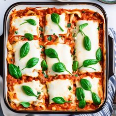 lasagna casserole with fresh basil on top in a baking dish, ready to be eaten