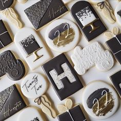 decorated cookies with black and white designs are arranged on a table together in the shape of letters that spell out happy birthday