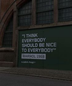 there is a sign on the side of a building that says i think everybody should be nice to everybody