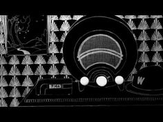 a black and white photo of an old fashioned radio with three balls in front of it