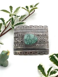 Here is a gift for anyone that wears a belt, even you. This is a great belt buckle. It is solid, heavy sterling silver with a 1 1/2 inch fixed loop made of sterling silver and a sterling tang. The beautiful and interesting cabochon is Emerald Valley turquoise from Nevada. The belt buckle is Navajo handmade with rows of interesting stamp work and a handmade saw cut bezel that adds even more style and class to an already classy buckle. The buckle is 3 inches wide by 2 1/2 inches deep, so is an app Classic Silver Buckle Belt Buckles As Gift, Classic Silver Buckle Belt As Gift, Rectangular Silver Belt Buckles For Gifts, Classic Silver Belt Buckles As Gift, Engraved Silver Belt Buckles As Gift, Classic Silver Belt Buckle As Gift, Adjustable Silver Southwestern Belt Buckles, Silver Bohemian Adjustable Belt Buckles, Artisan Engraved Belt Buckles As Gift