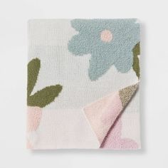 a blanket with flowers on it and a pink flower in the middle is folded up