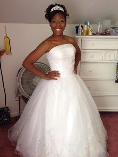 a woman in a white wedding dress posing for the camera