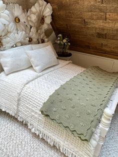 a bed with white flowers on top of it