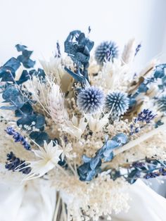 a vase filled with blue and white flowers