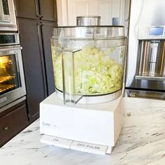 a blender filled with food sitting on top of a counter next to an oven