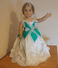 A magical, one of a kind ballgown for 18 inch dolls. This outfit comes in two pieces: 1.) The Dress: A gorgeous off white satin dress with organza and lace overskirts and a bodice made of crushed green satin petals/leaves trimmed with lace and pearls. Features handmade 3D chiffon flowers along the lower edge of the skirt. Has hook-and-loop tape in the back for ease of closure. 2.) The Veil: An off-white organza veil trimmed with handmade 3D chiffon flowers and gothic lace. Secures to doll's hair via bobby pin (included). Lace Princess Dress Ball Gown For Dress-up, Lace Ball Gown With Fitted Bodice, Lace Ball Gown Pageant Dress With Fitted Bodice, Lace Bodice Ball Gown Pageant Dress, Lace Ball Gown Pageant Dress For Wedding, Lace Ball Gown Pageant Dress With Lace Bodice, Princess Style Lace Pageant Dress For Wedding, Princess Lace Pageant Dress For Wedding, Lace Ball Gown For Pageant