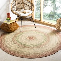 a round rug in the corner of a room with a wicker chair next to it