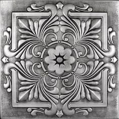 an intricately designed metal plate with decorative designs