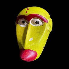 a yellow mask with red nose and eyes