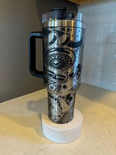 a black and silver cup sitting on top of a counter