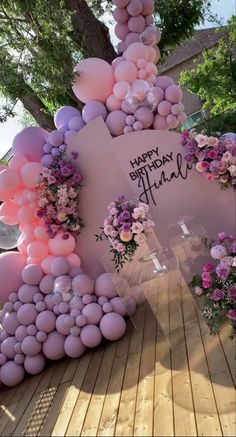 balloons and flowers are arranged in the shape of an eiffel tower