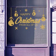 a sign on the side of a building that says happy christmas from all of us