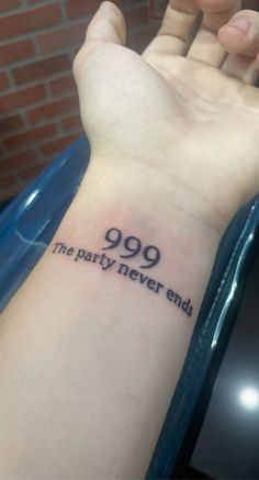 a person with a tattoo on their arm saying 999 the party never ends,