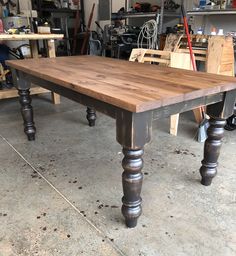 a wooden table sitting inside of a garage