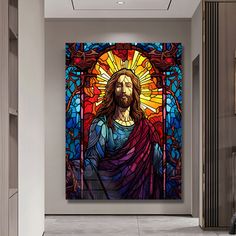 a large stained glass window with jesus on it in a hallway next to a wall