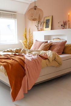 a bed with blankets and pillows in a room