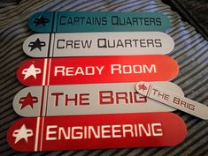 some signs are on top of a bed and one is reading, ready room, the big engineering